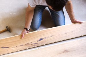 Person laying wood flooring
