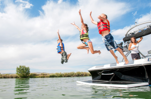 Kids jumping off boat into water