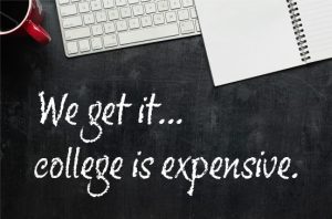 white board surface that says "we get it, college is expensive" and shows a coffee mug, computer keyboard, and notebook