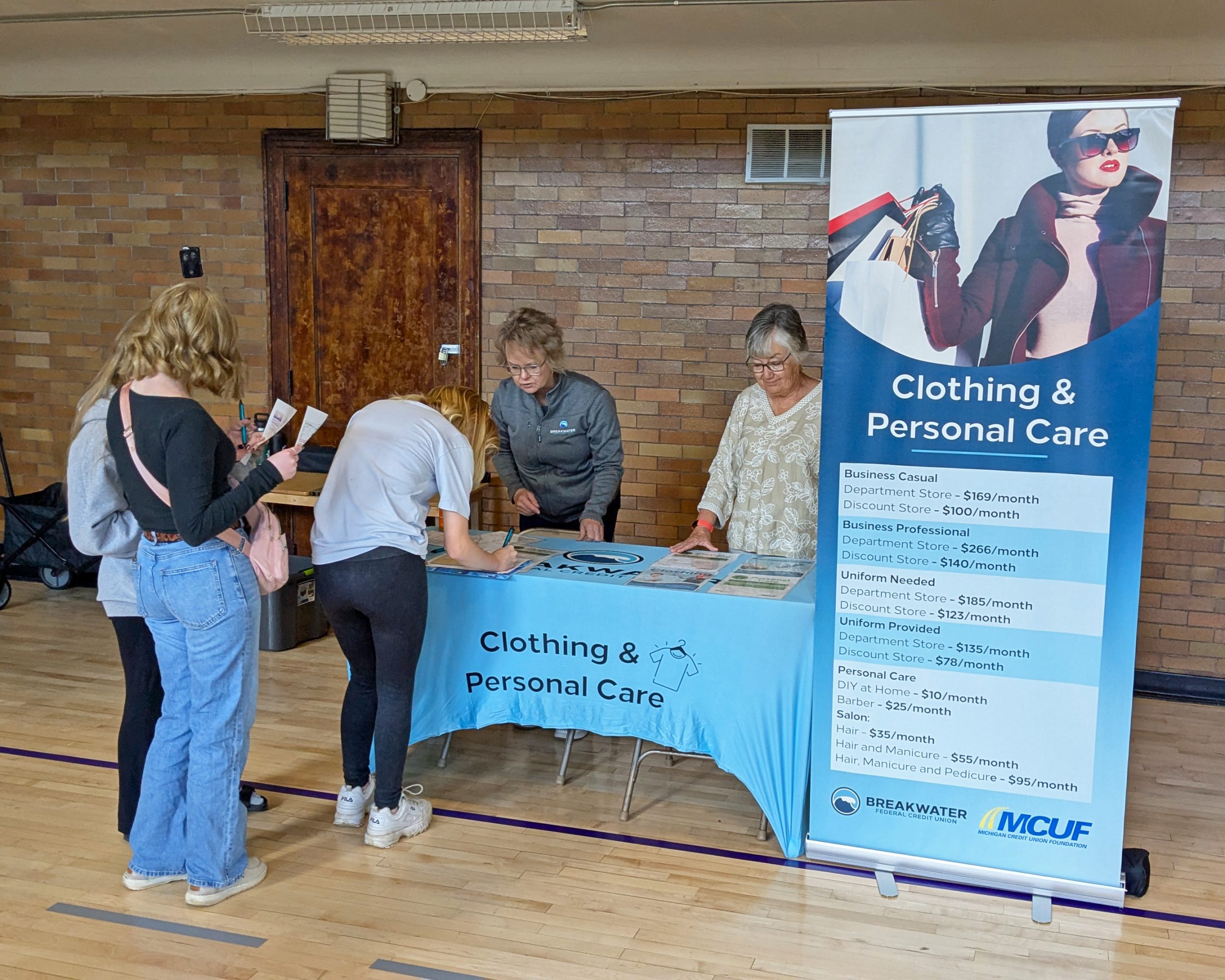 Photo of the clothing & personal care station with pop-up banner and tablecloth.