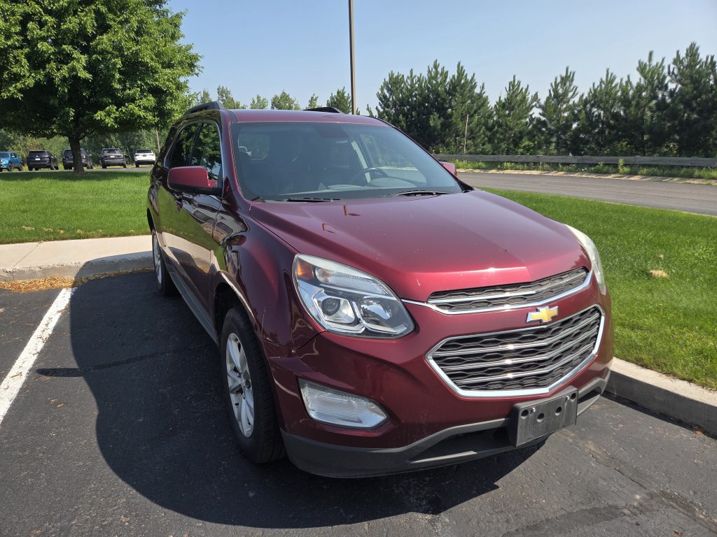 Photo of exterior from passenger side front. Red Chevy Equinox