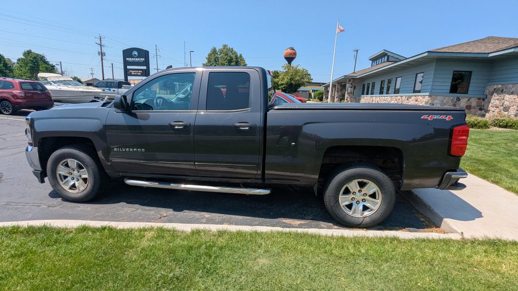 Exterior drivers side of chevy truck for sale. Dark grey exterior.