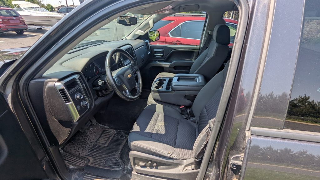 Interior taken from driver side- gay interior, medium dash screen, power seats