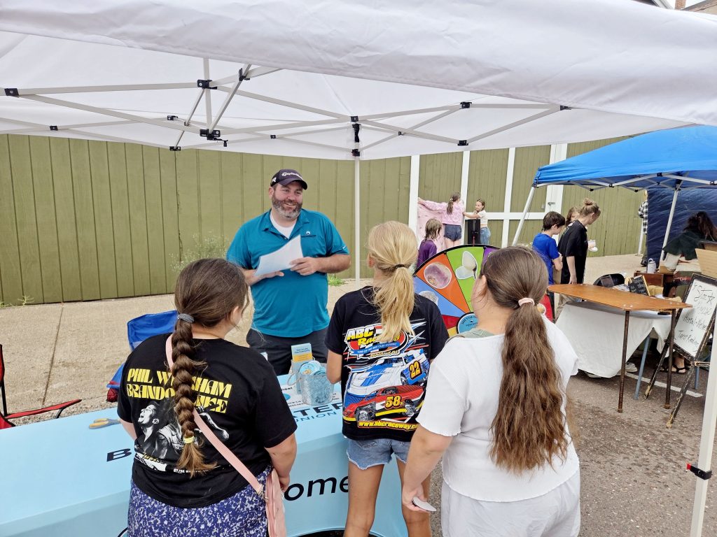 Breakwater staff asks a group of three young girls trivia questions about cost of pasty ingredients in 1898 vs. today.