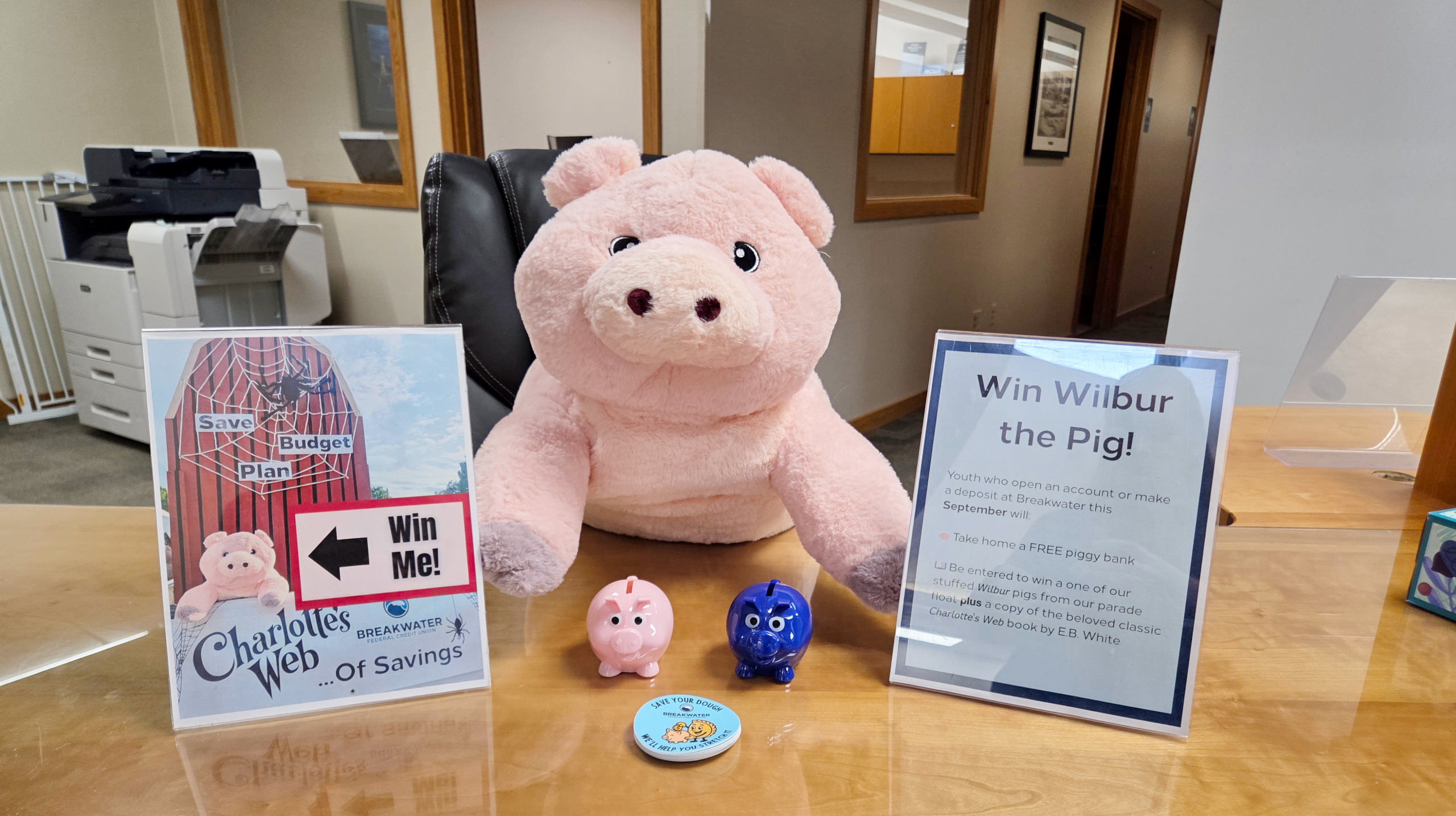 Stuffed pig on display in Breakwater lobby with piggy banks