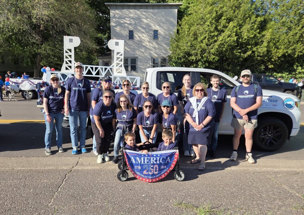 Breakwater employees and friends and family pose for a picture with their Bridgefest float.