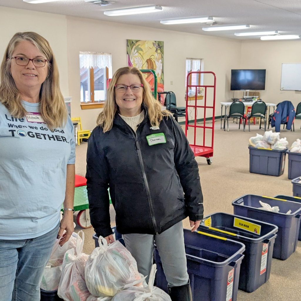 Employees smile for a picture while volunteering for 31 Backpacks.